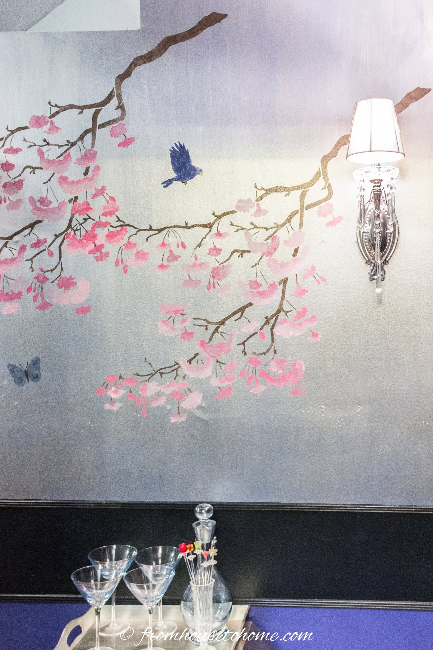 A silver hallway wall painted with a DIY Chinoiserie cherry blossom stencil
