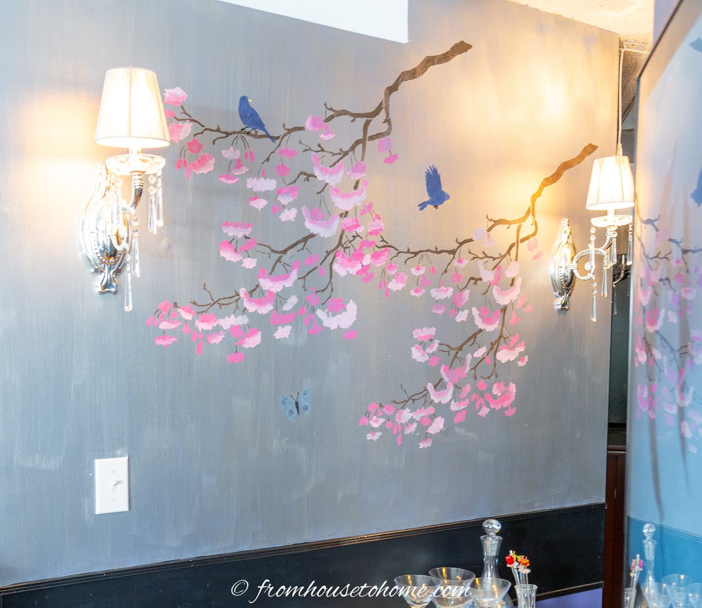 A silver hallway wall painted with 2 pink cherry blossom branches