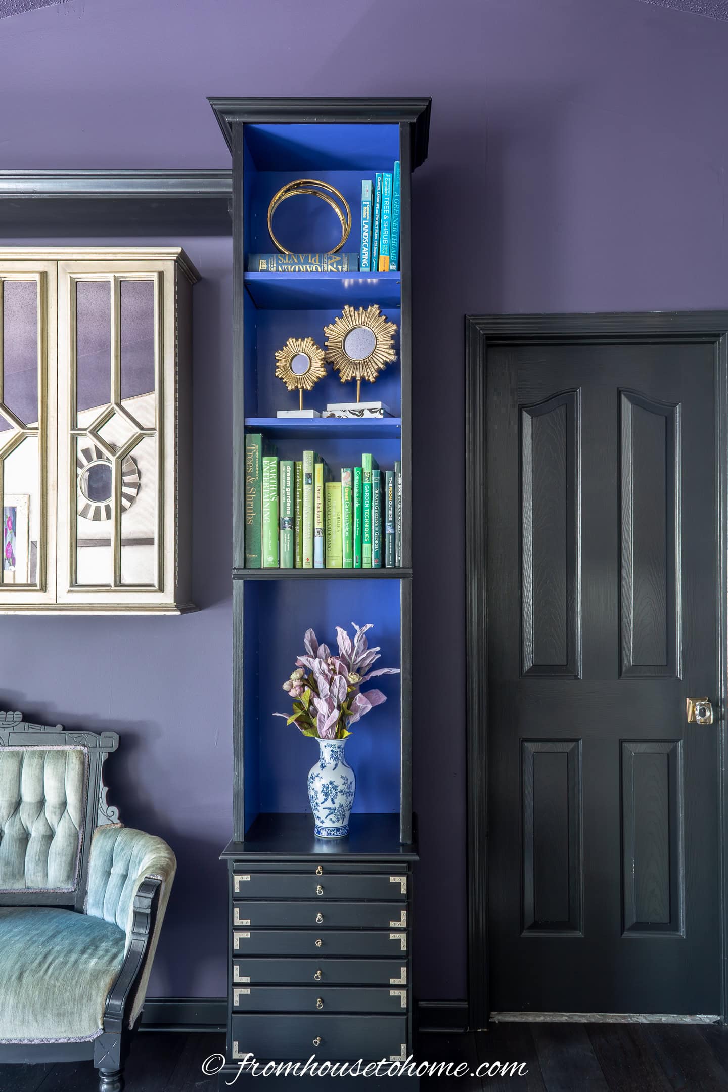 A purple bedroom with the doors and trim painted black