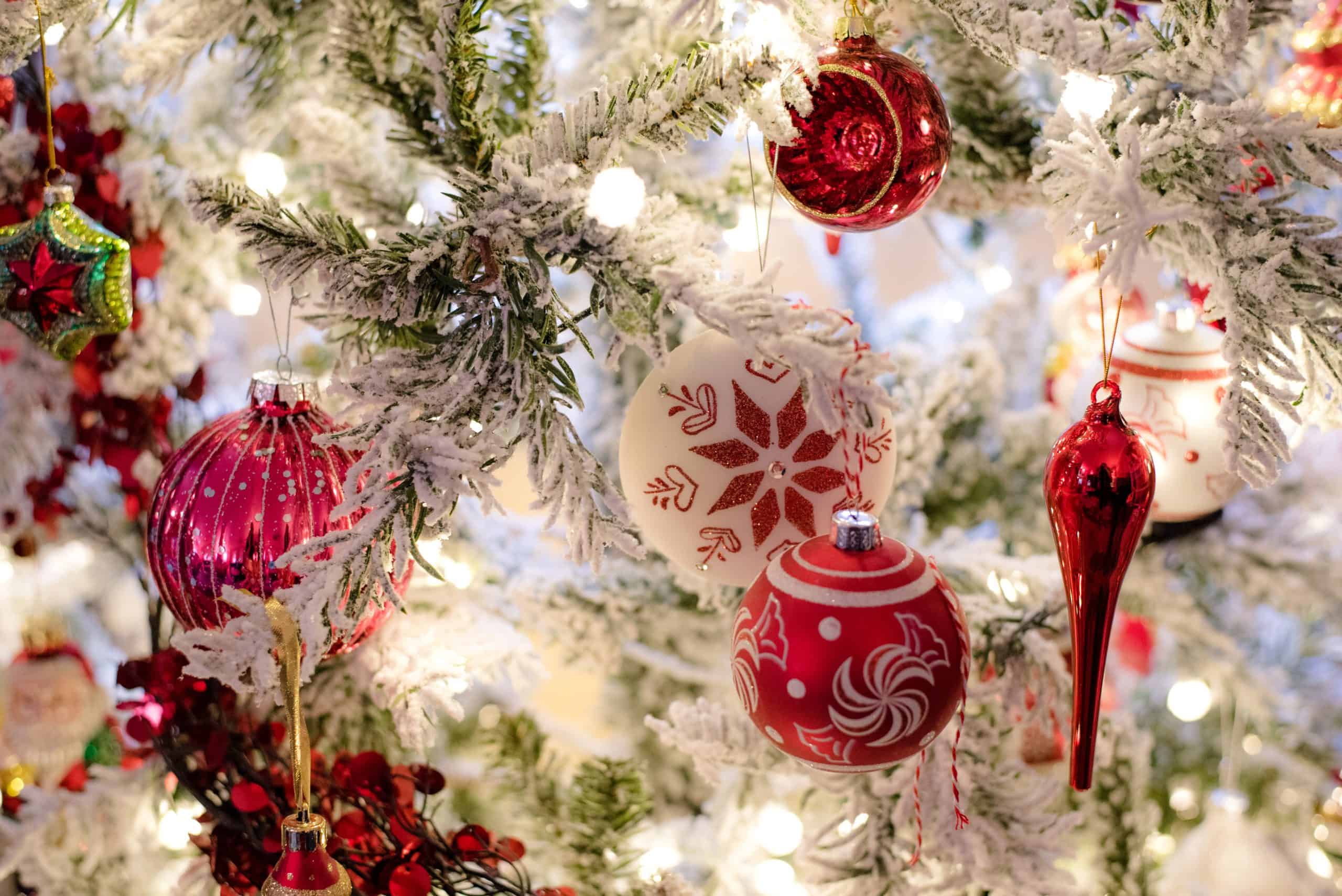slim flocked christmas tree with red and white ornaments