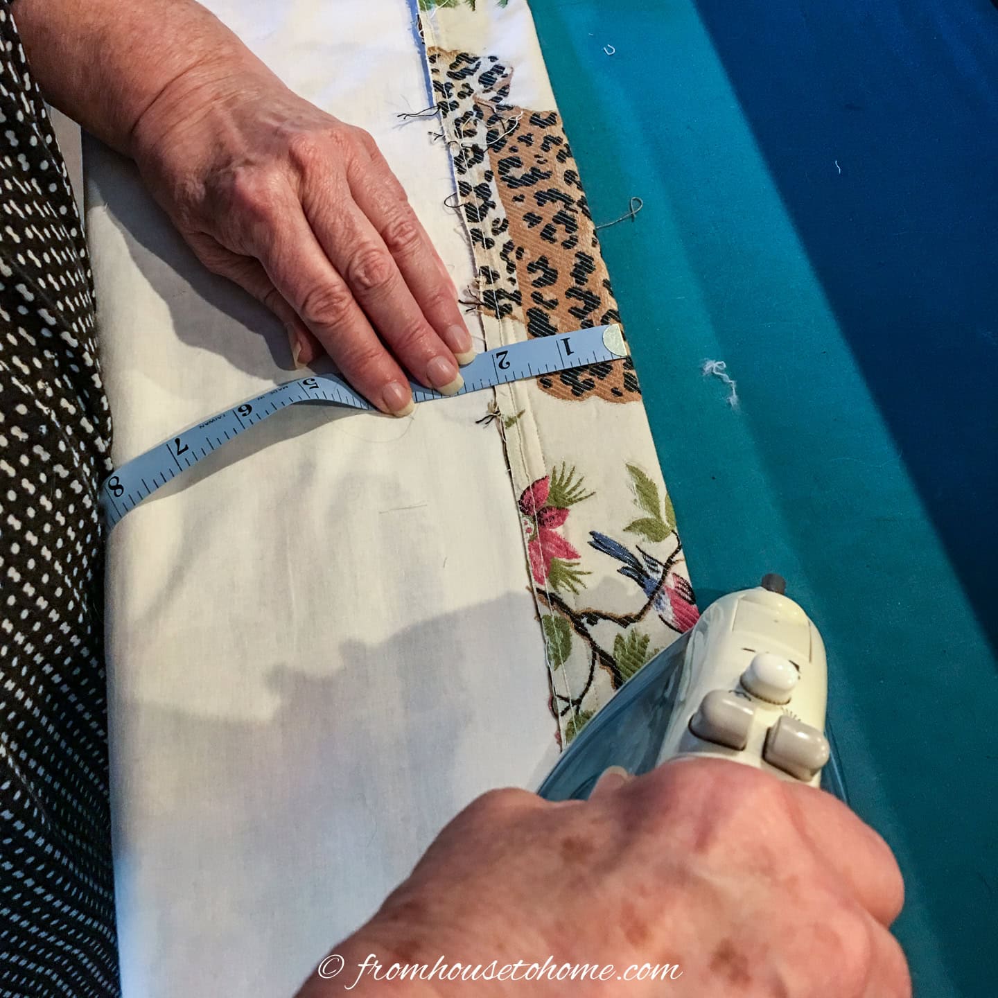 A 2-inch hem being ironed at the bottom of a roller blind