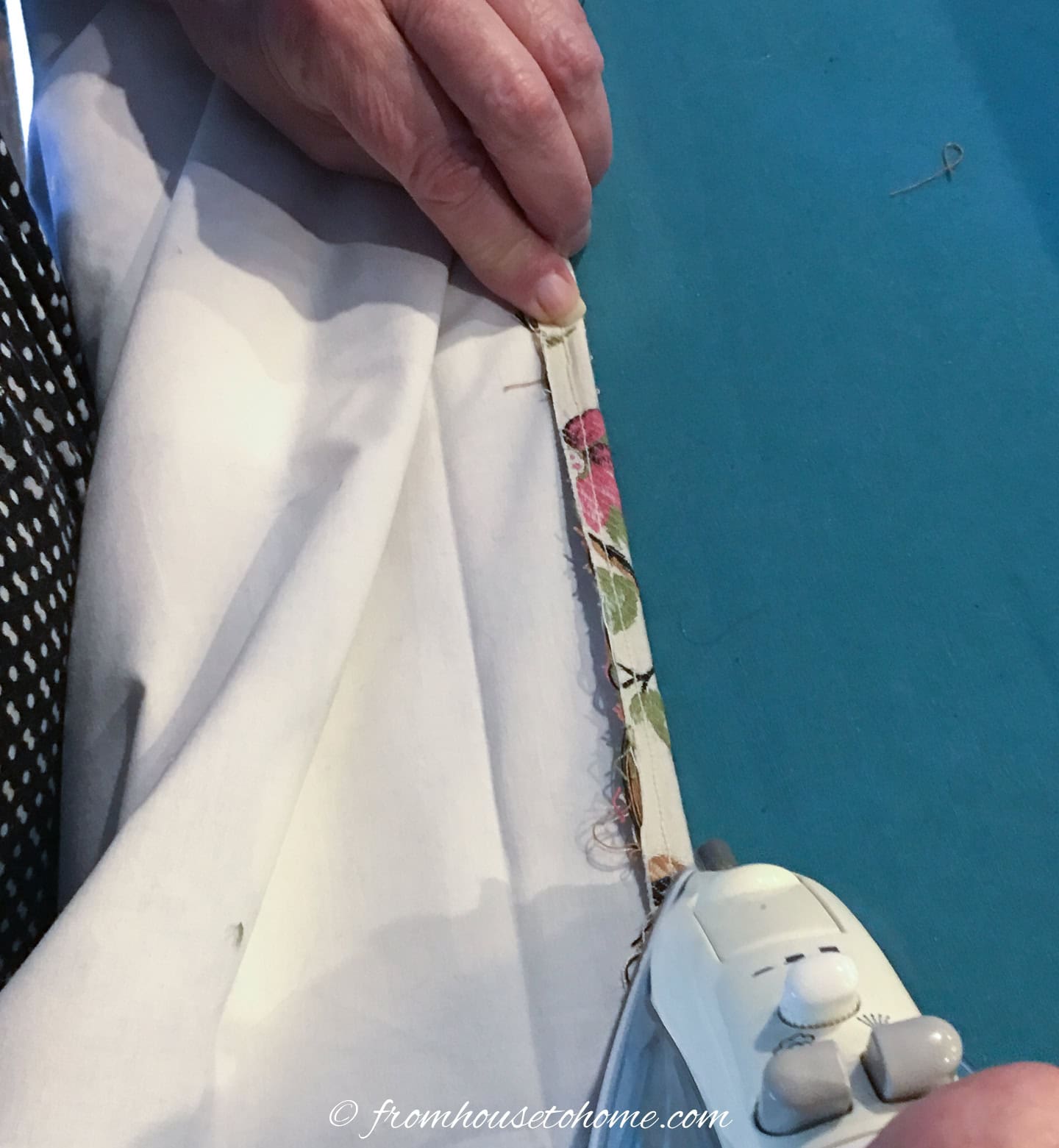 A half-inch hem being ironed at the bottom of a roller blind