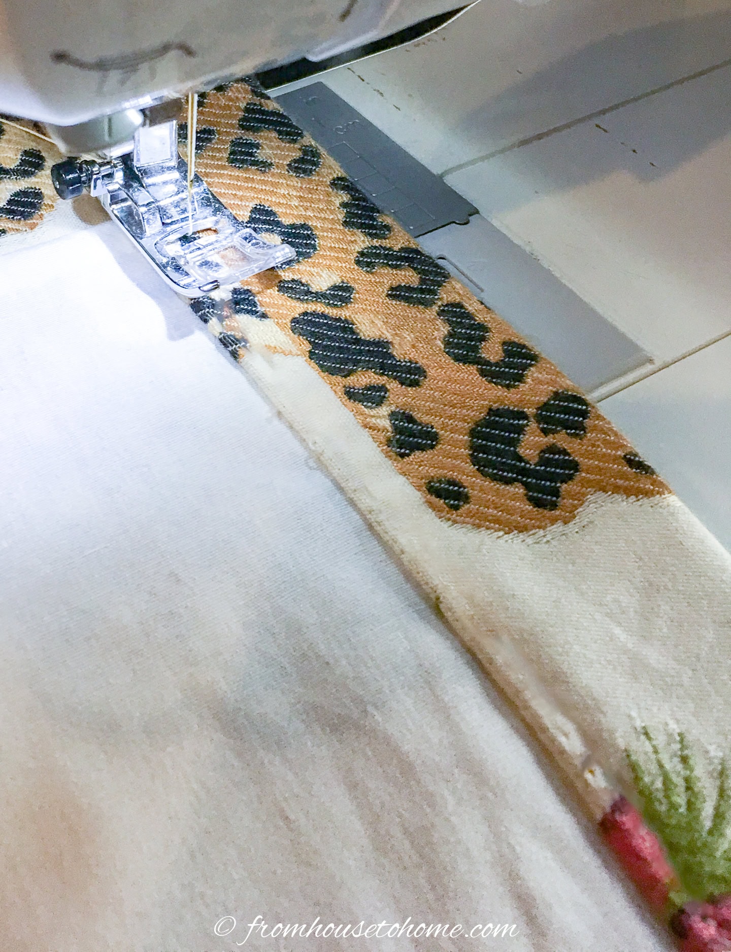 A sewing machine sewing along the bottom channel of a roller blind