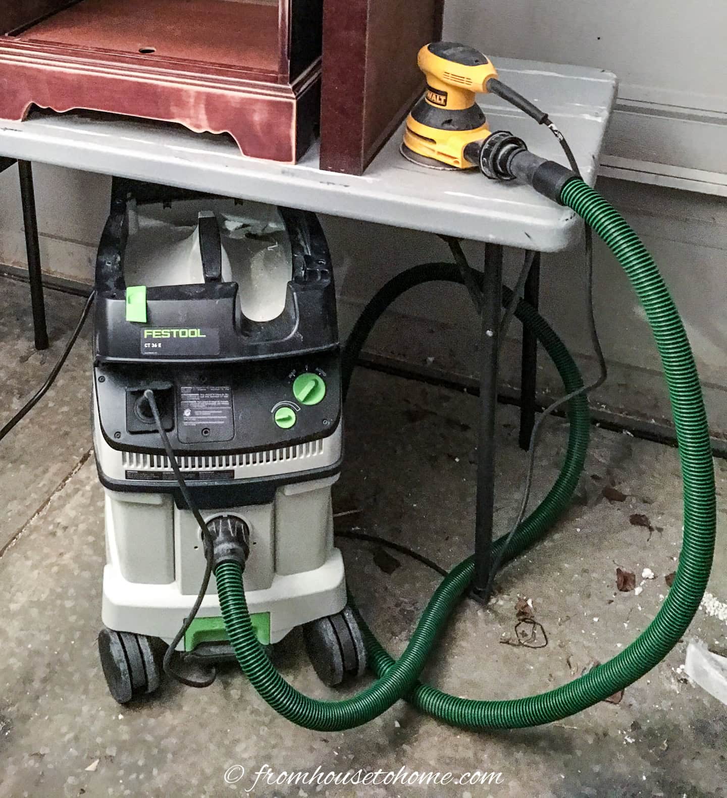 a Festool dust extractor hooked up to a sander