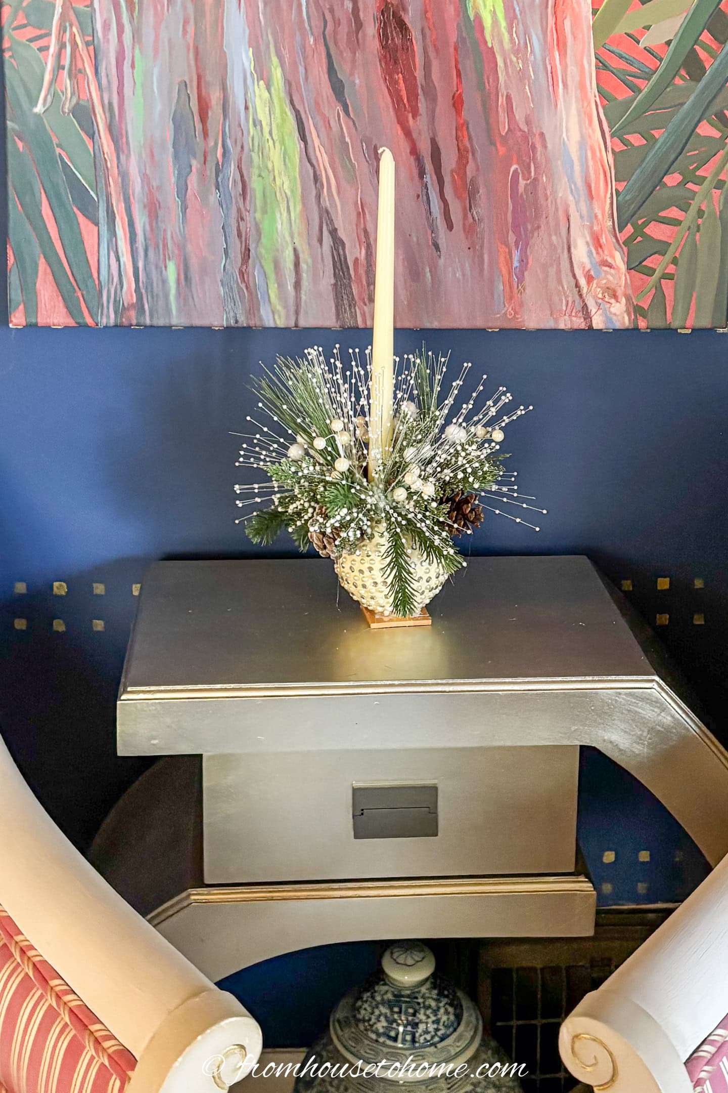 A small white DIY Christmas centerpiece made from an ornament on a small table