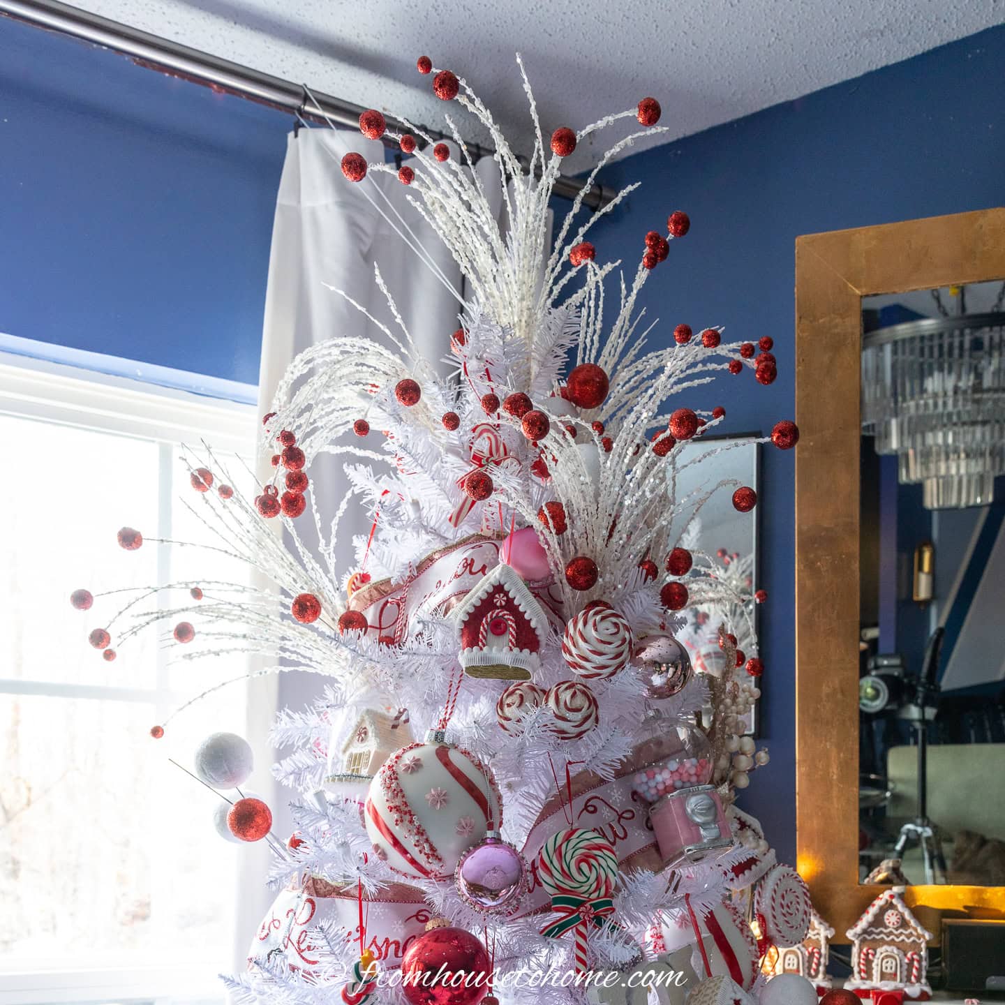 White and red picks used as a tree topper on a candyland Christmas tree