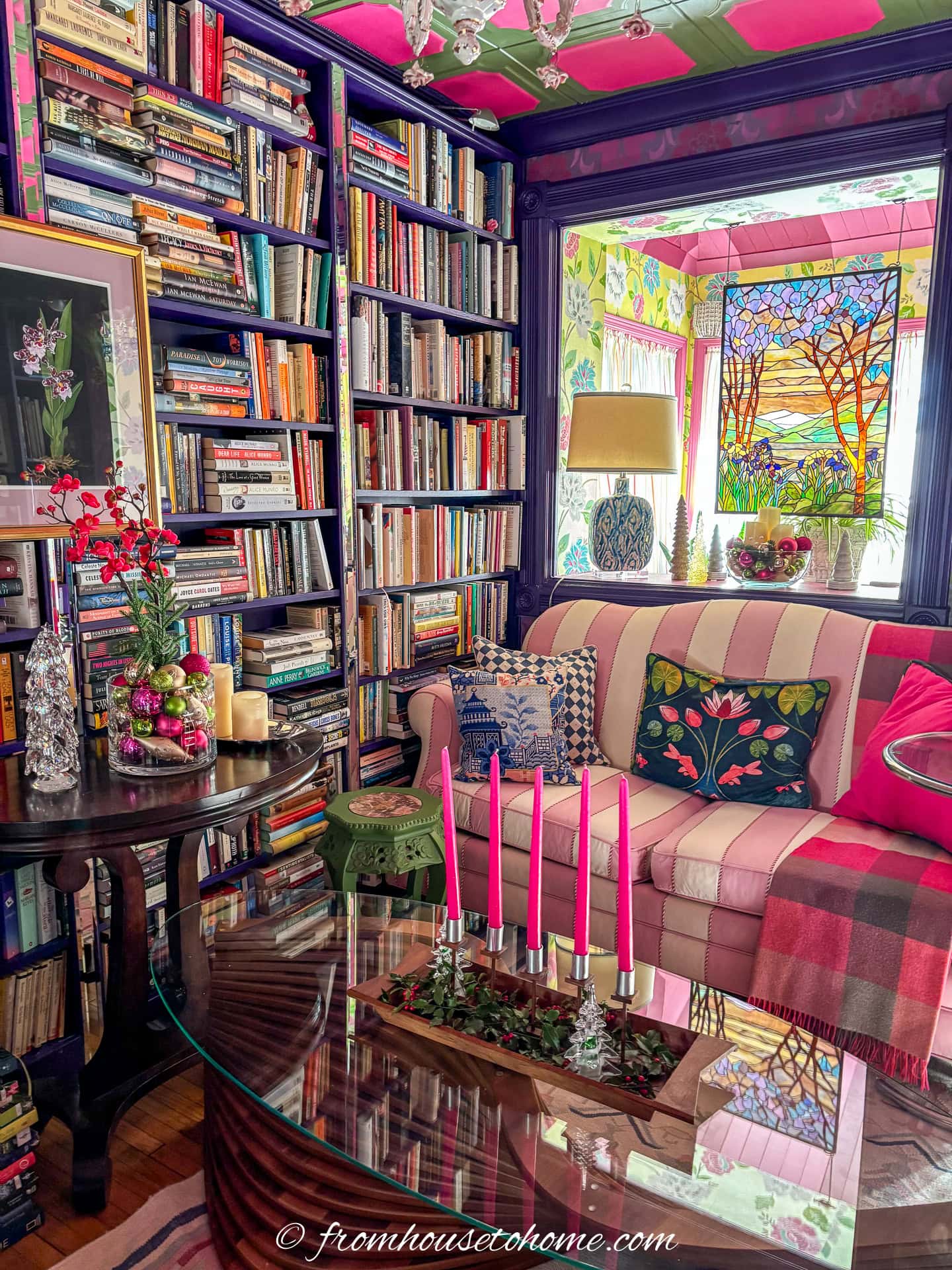 A living room decorated with fuchsia pink, lime green and gold accessories for Christmas