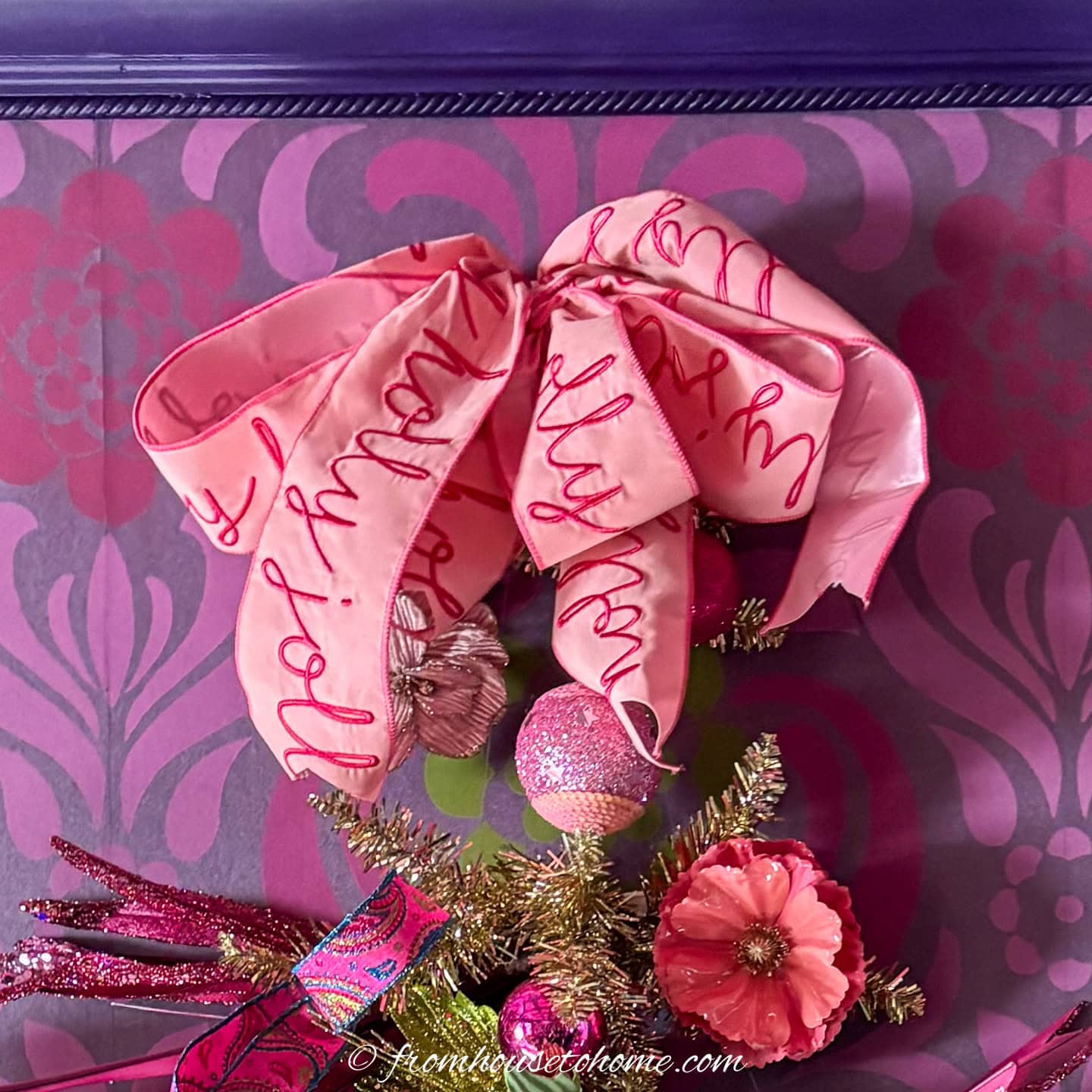 Close up of a bow tree topper on a wall tree