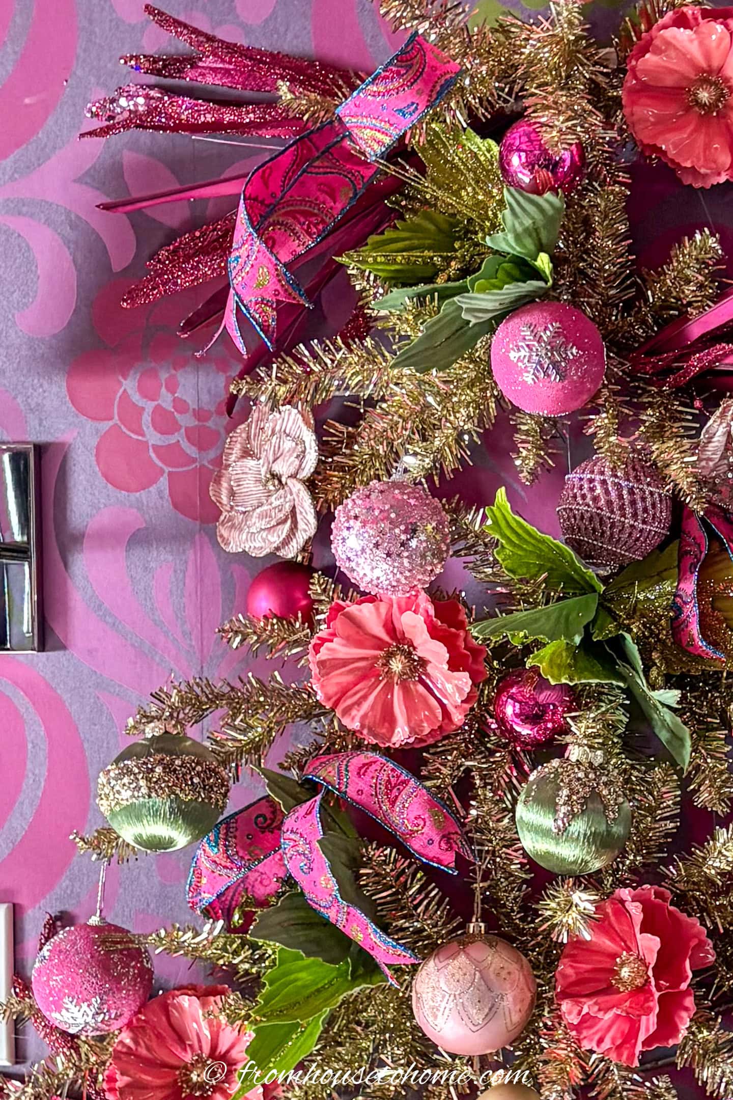 Close up of a fuchsia, lime green and gold wall tree