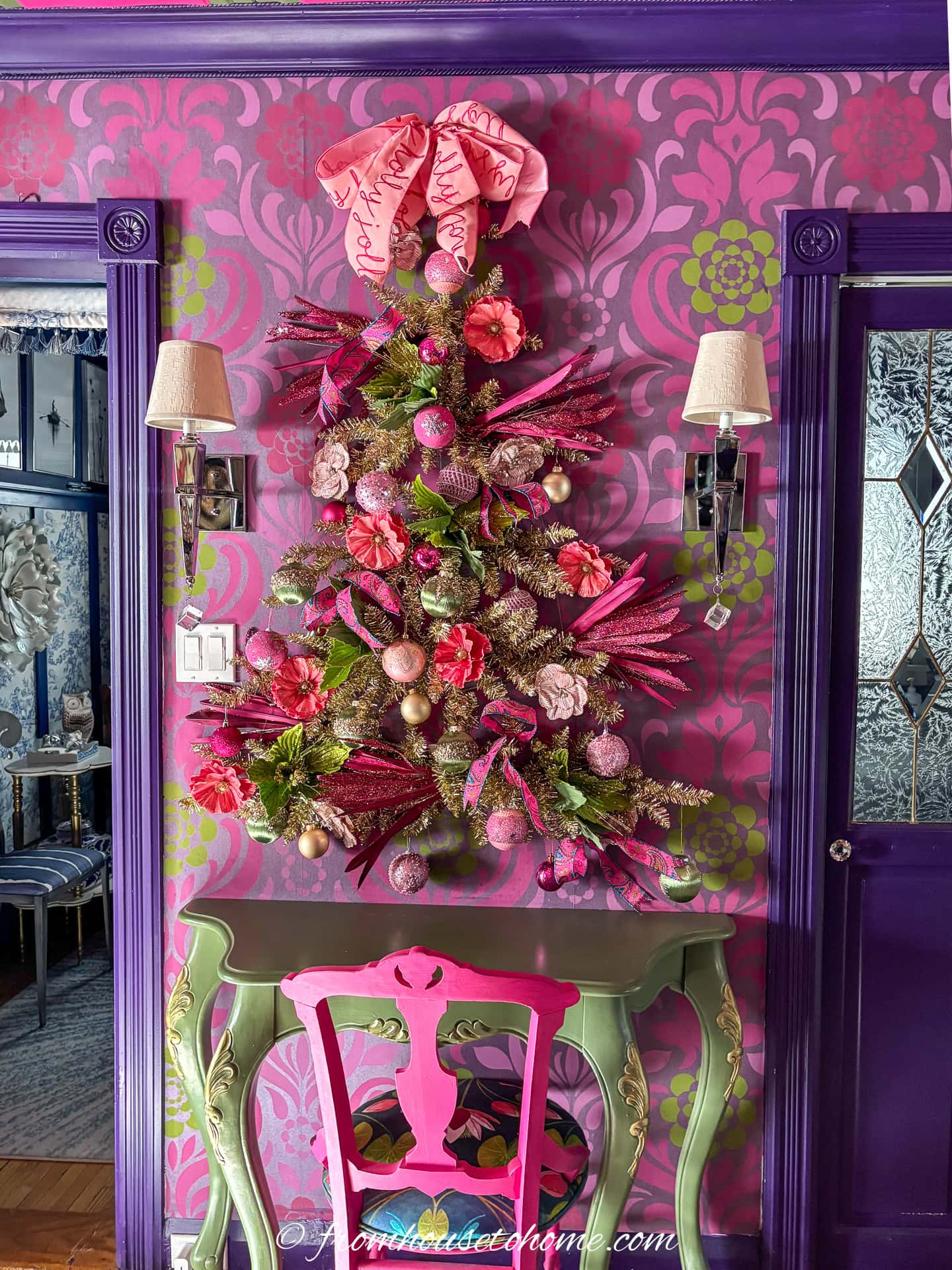A wall Christmas tree over a console table in a small living room