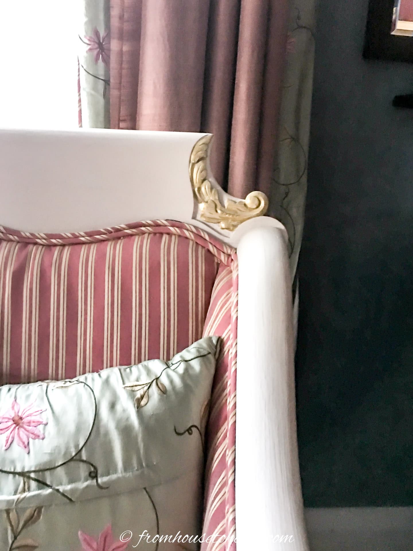 Close up of a white chair with the details painted gold