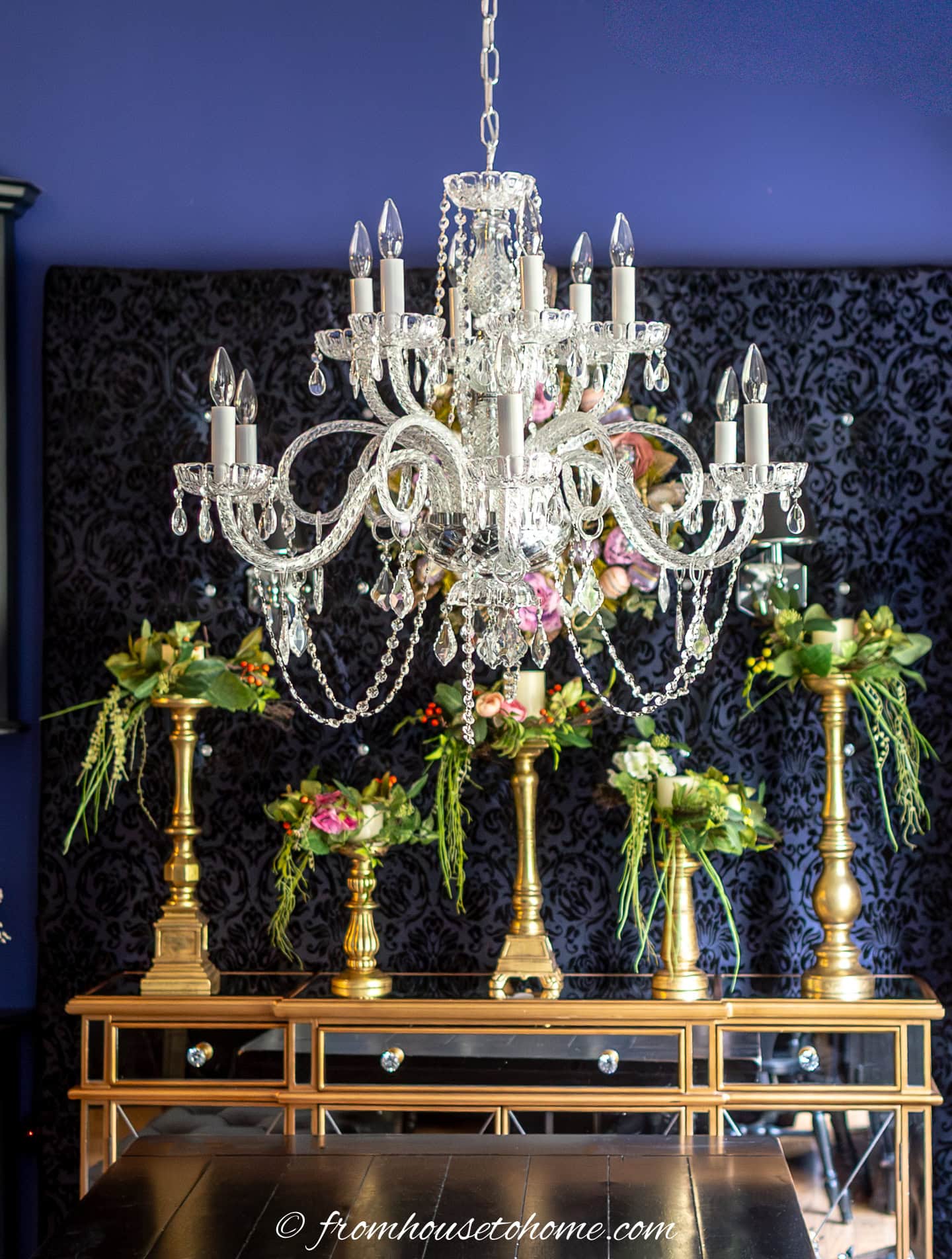 A chandelier hanging over a dining over room table