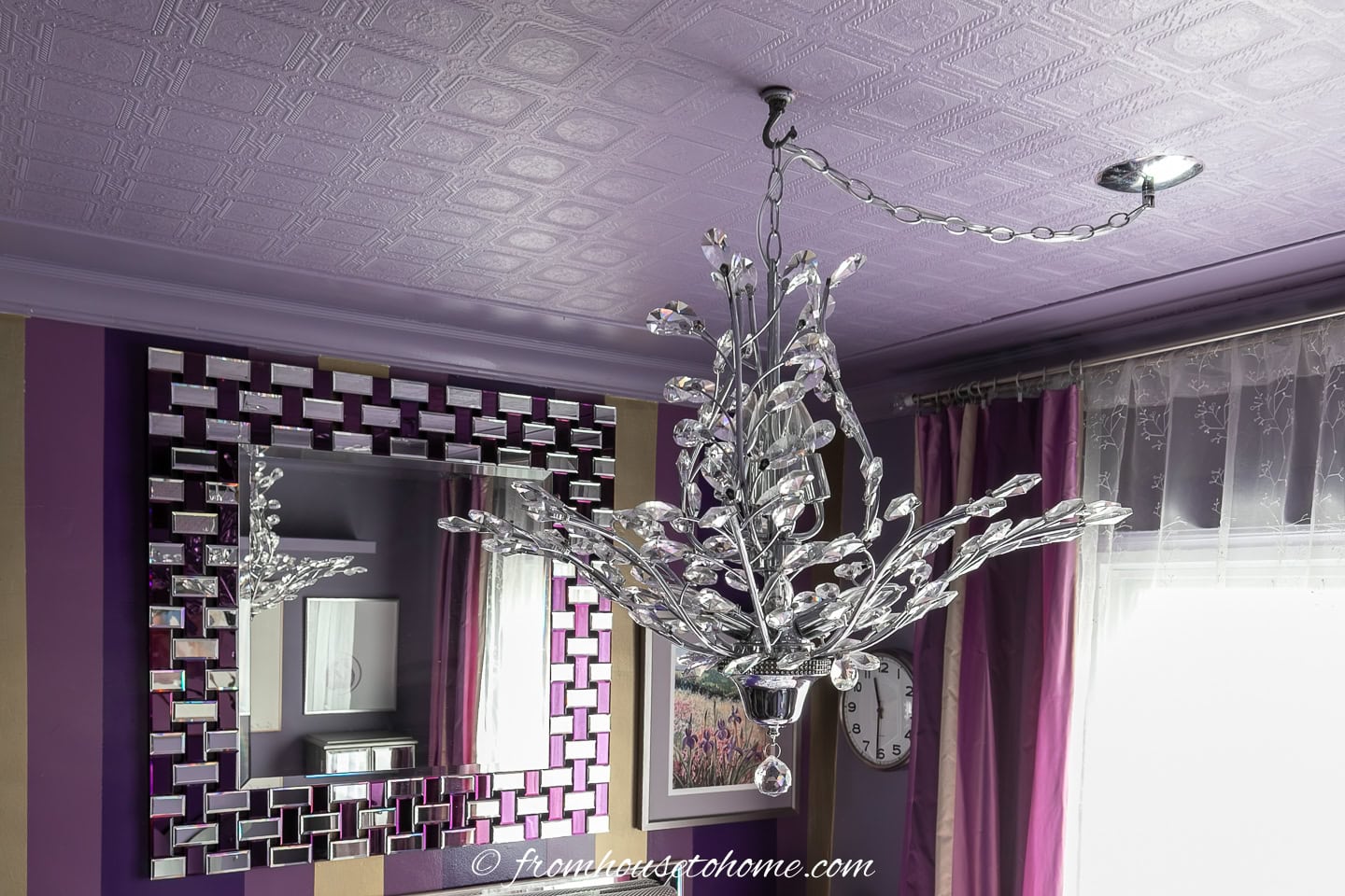A chandelier installed in a purple bedroom