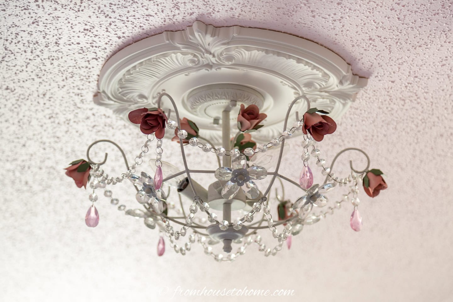 semi-flush mount light fixture on a pink ceiling
