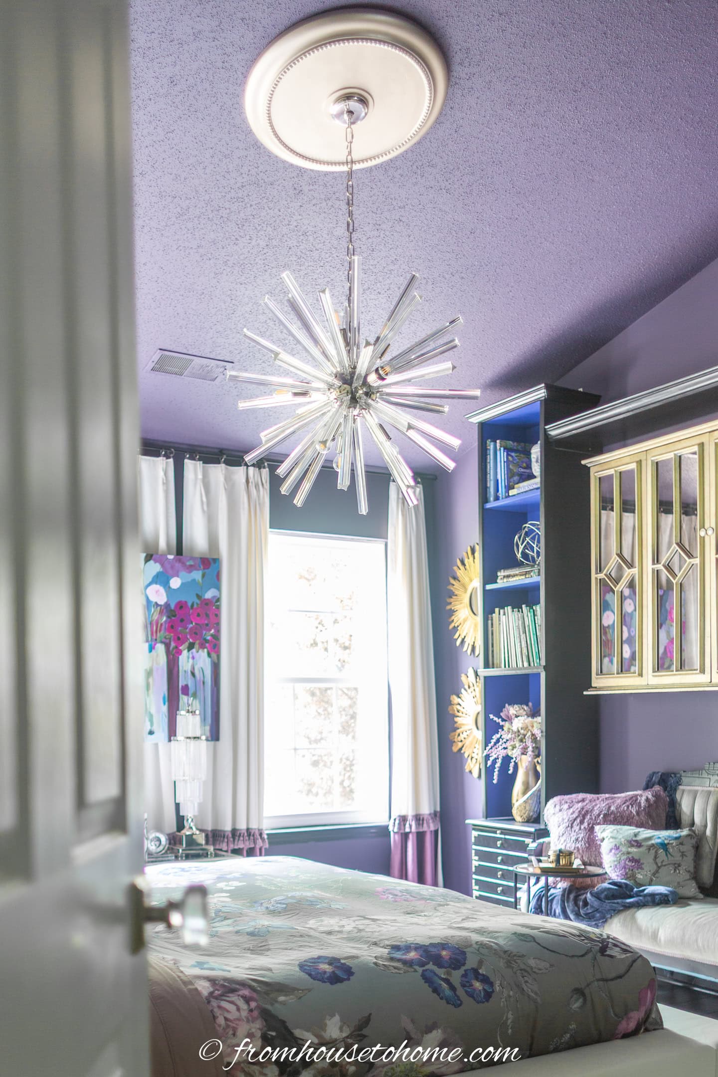 A sputnik chandelier provides general room lighting in a bedroom