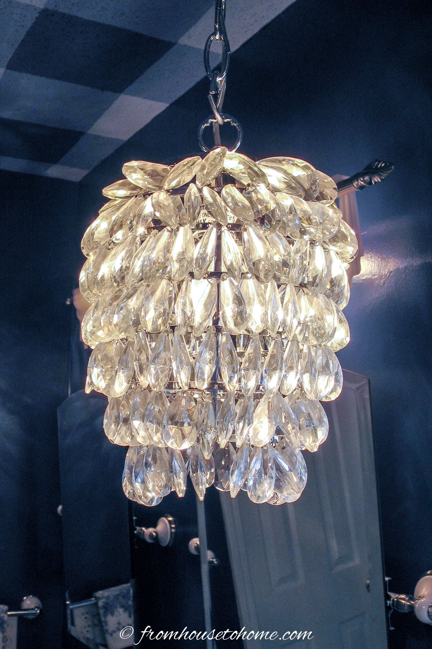 close up of a crystal pendant in a blue bathroom