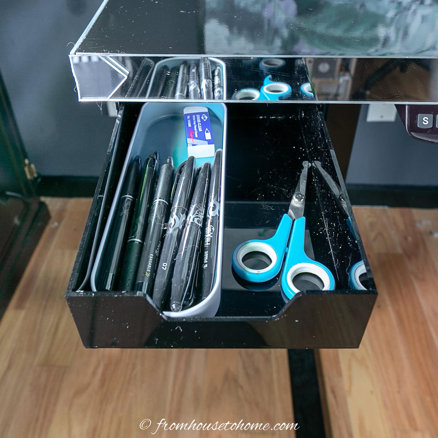 A small drawer attached to one corner of the sit stand desk