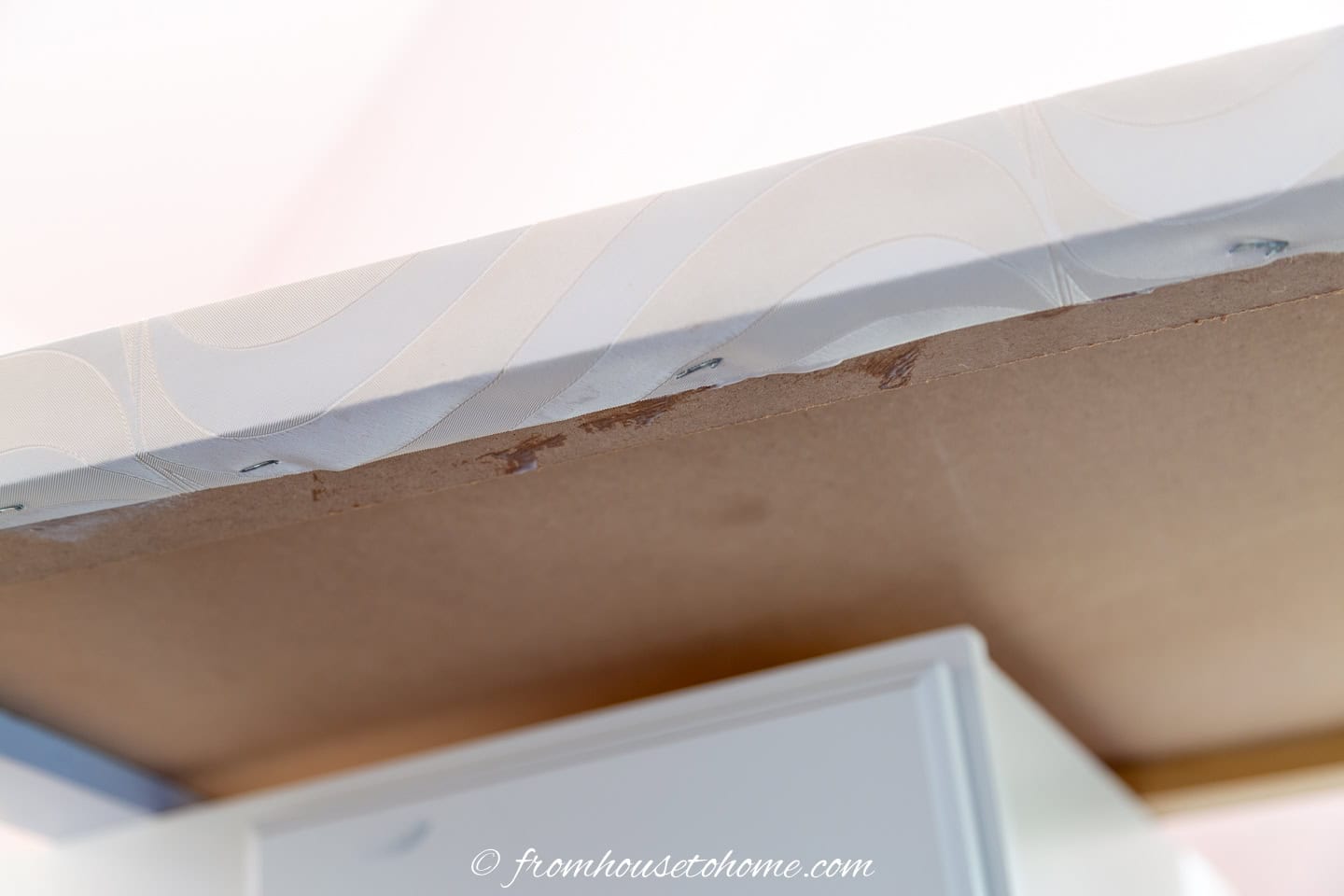 Wallpaper stapled under a square-edge countertop