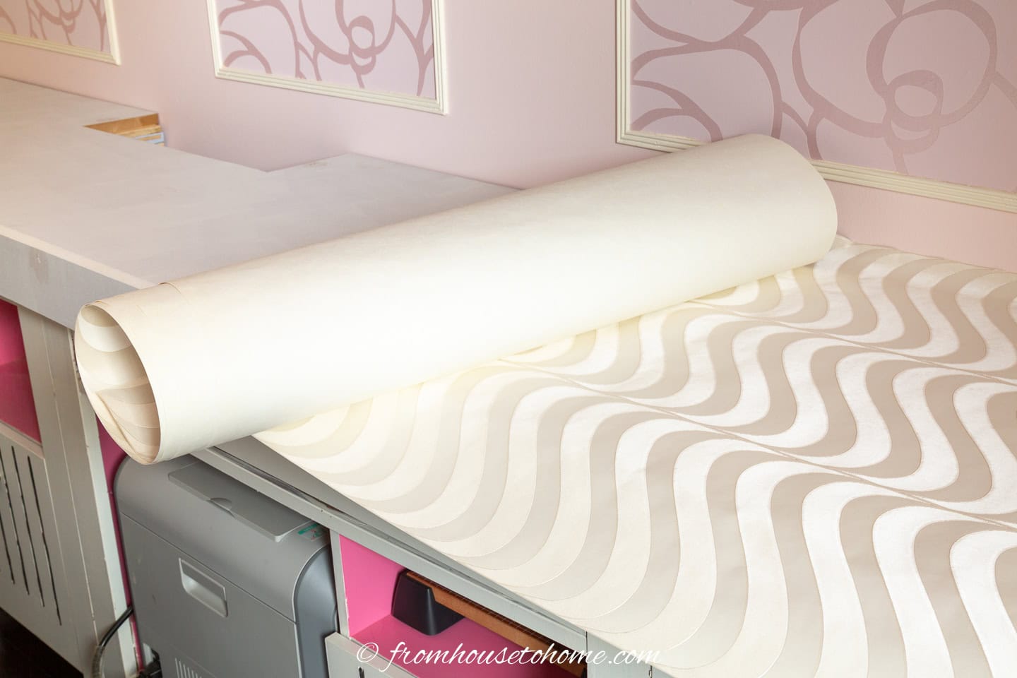 Roll the wallpaper up with the back facing outward