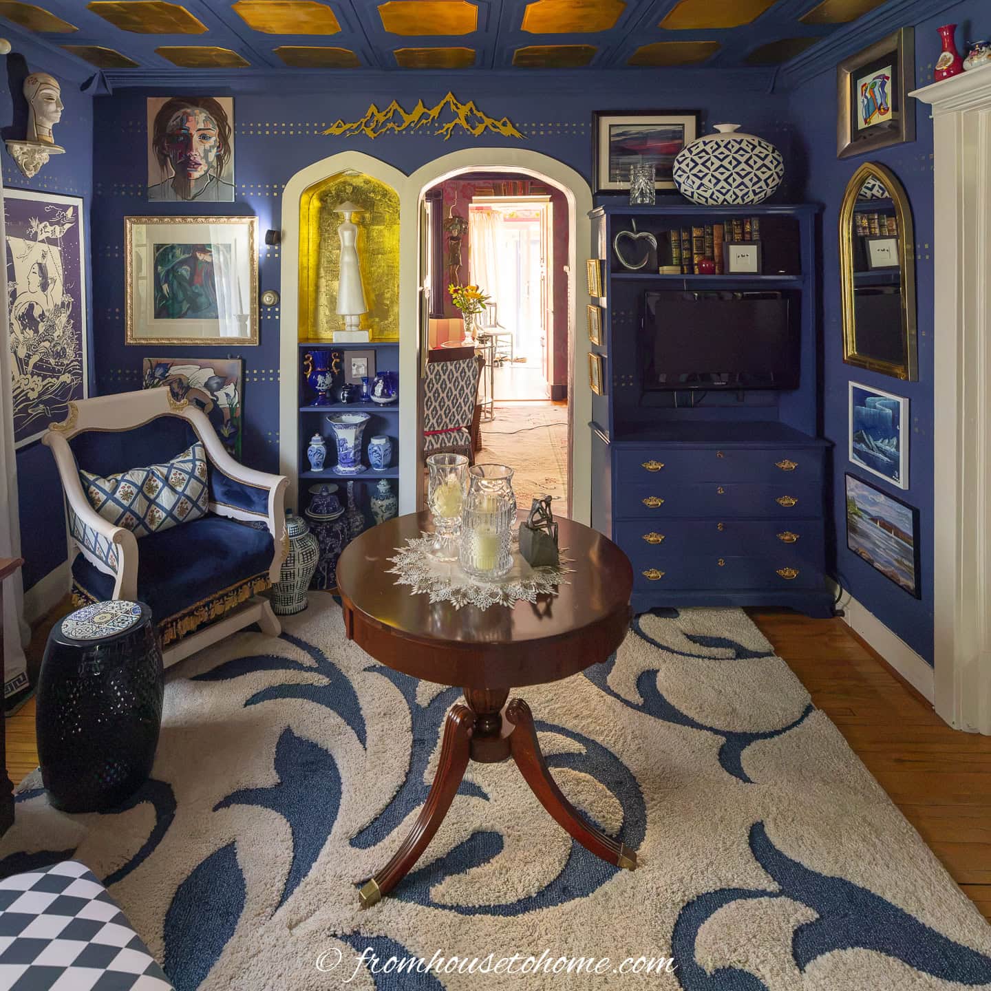 DIY navy blue painted bookshelves in a navy blue living room