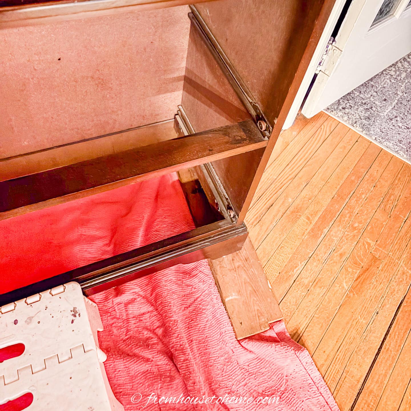 a floor covering and wood under a bookshelf to be painted