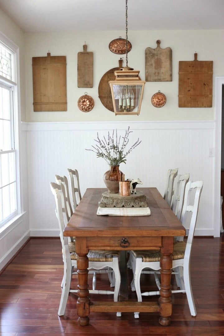 A collection of cutting boards on a dining room wall