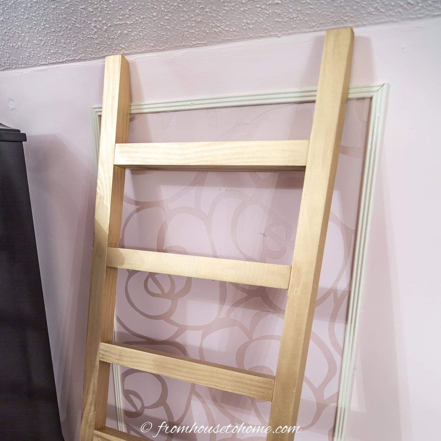 The top of the blanket ladder leaning against the wall