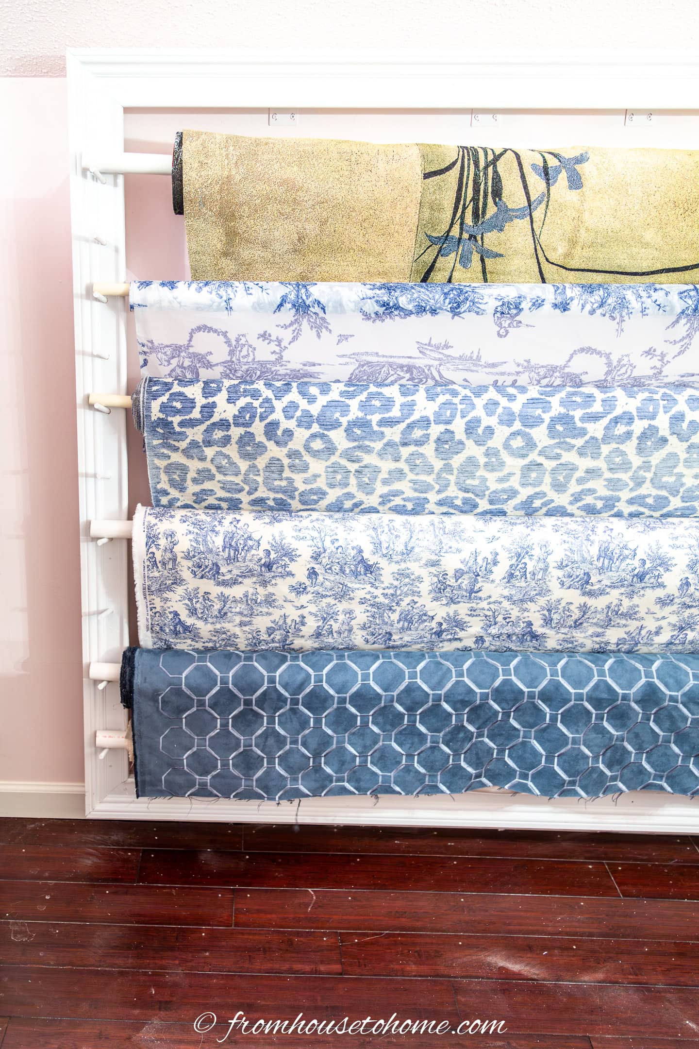 One side of the finished fabric roll storage rack with rolls of fabric on it