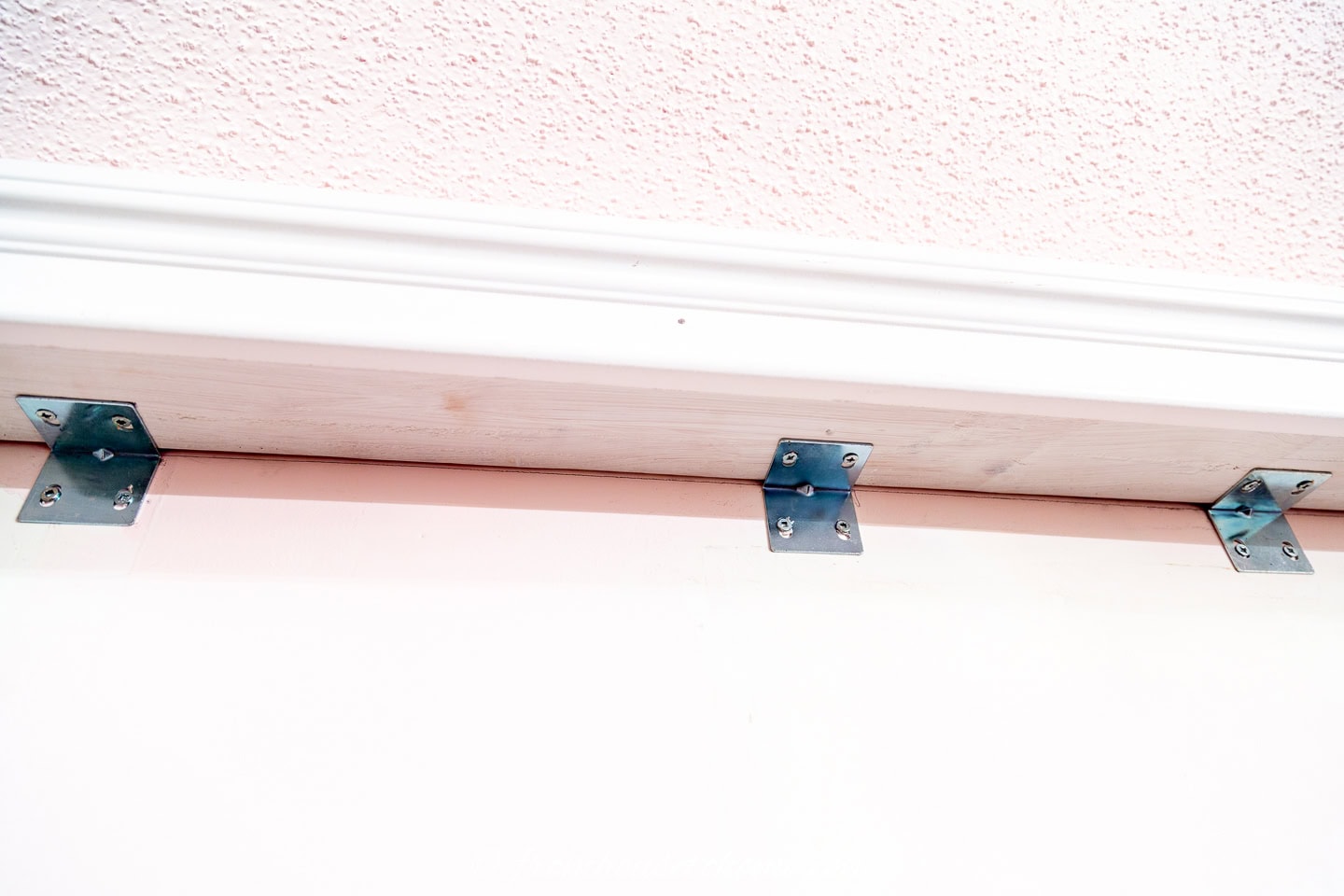 Install Angle brackets under the top rail