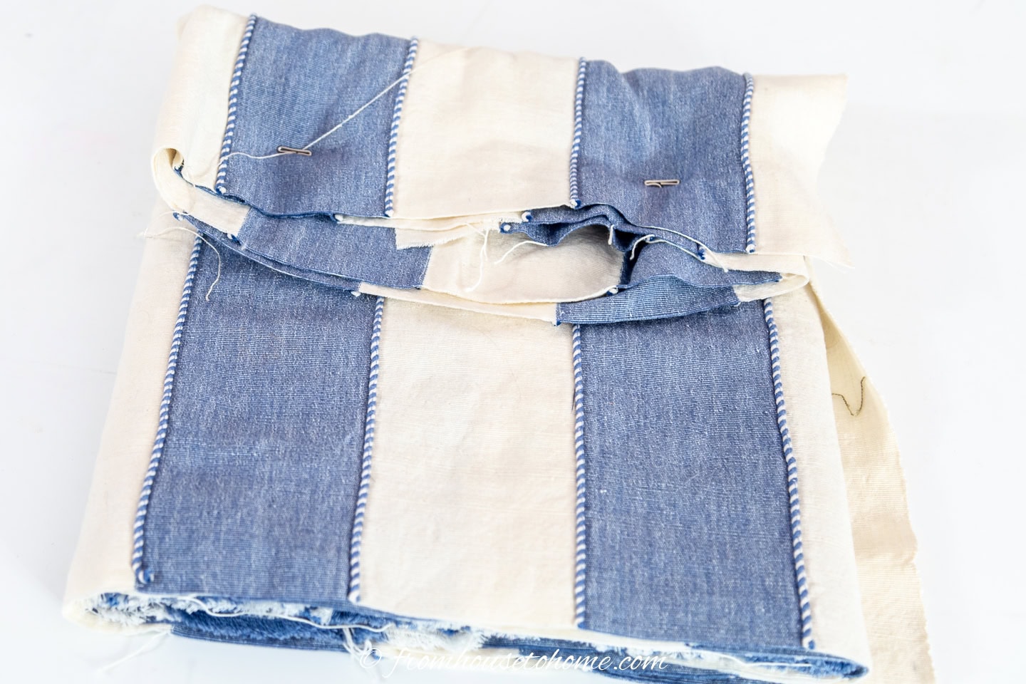 Additional upholstery T pins securing the loose edges of the fabric