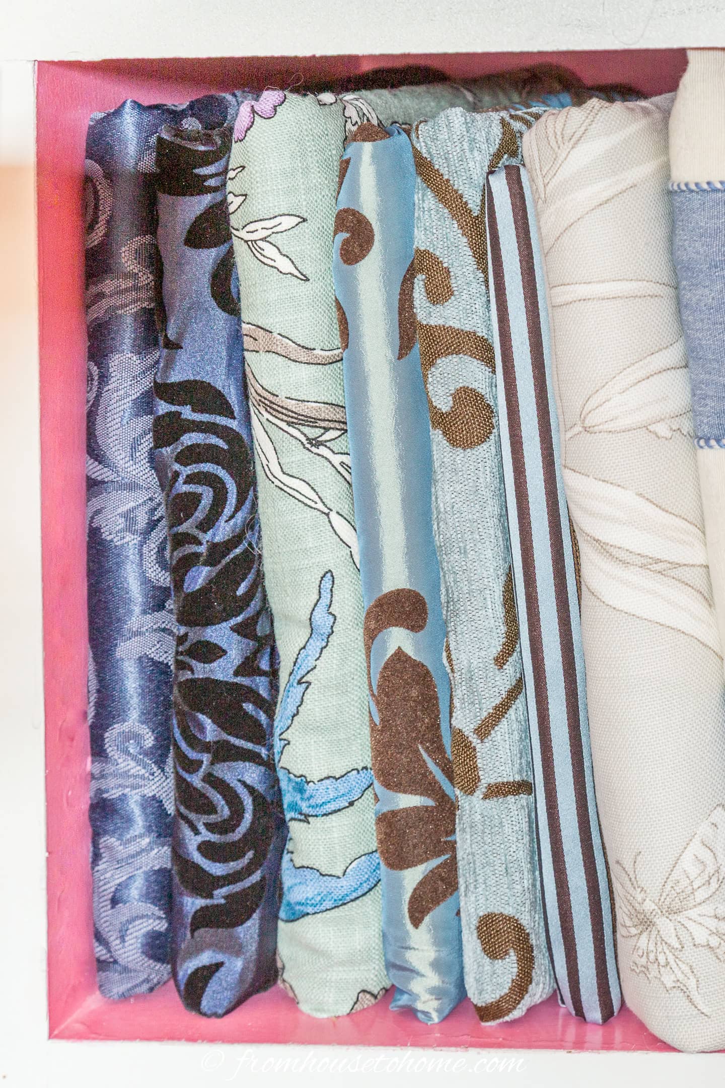 Close up of fabric-wrapped cards on a bookshelf