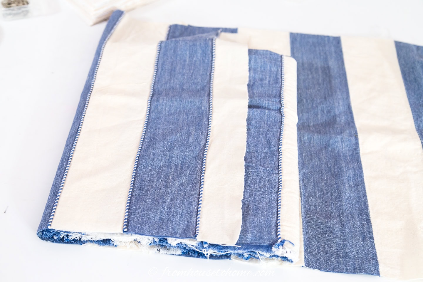 A second piece of fabric being folded over the card