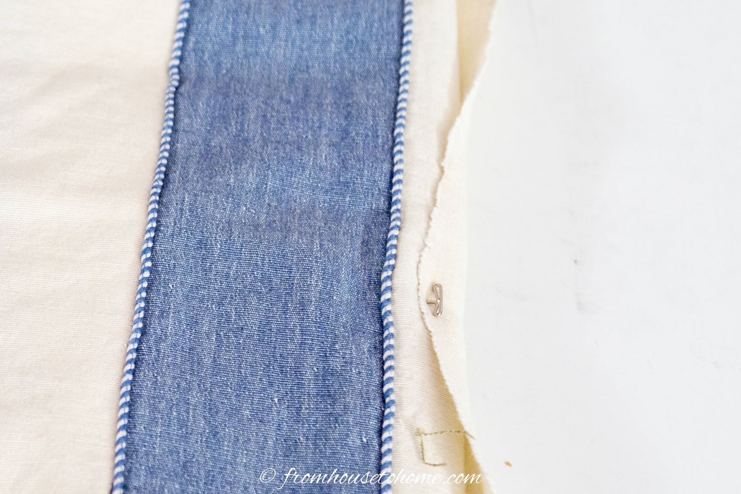 The end of the fabric pinned to the board with a T-pin