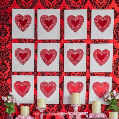 DIY Valentine's Day decor made of red heart doilies on white canvas