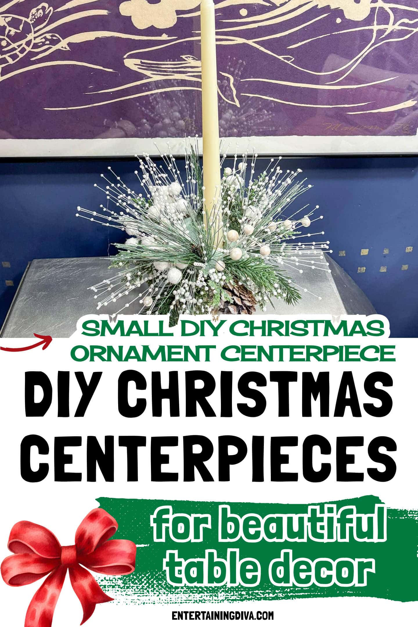 A tall cream-colored candle is surrounded by artificial pine branches, berries, and pinecones, arranged in a festive centerpiece on a table with a purple artwork in the background.